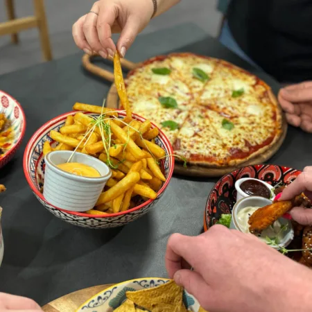 Guests sharing Mexican-inspired pizza and plates from The Mad Mexican.