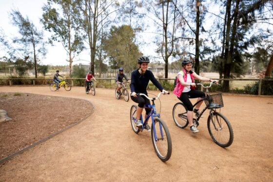 People riding bicycles around Taronga Western Plains Zoo.