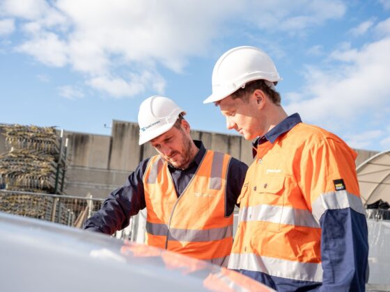 Construction workers reviewing plans on site, highlighting the need for worker accomodation in Dubbo.